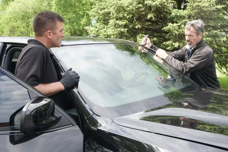 workers repairing car glass